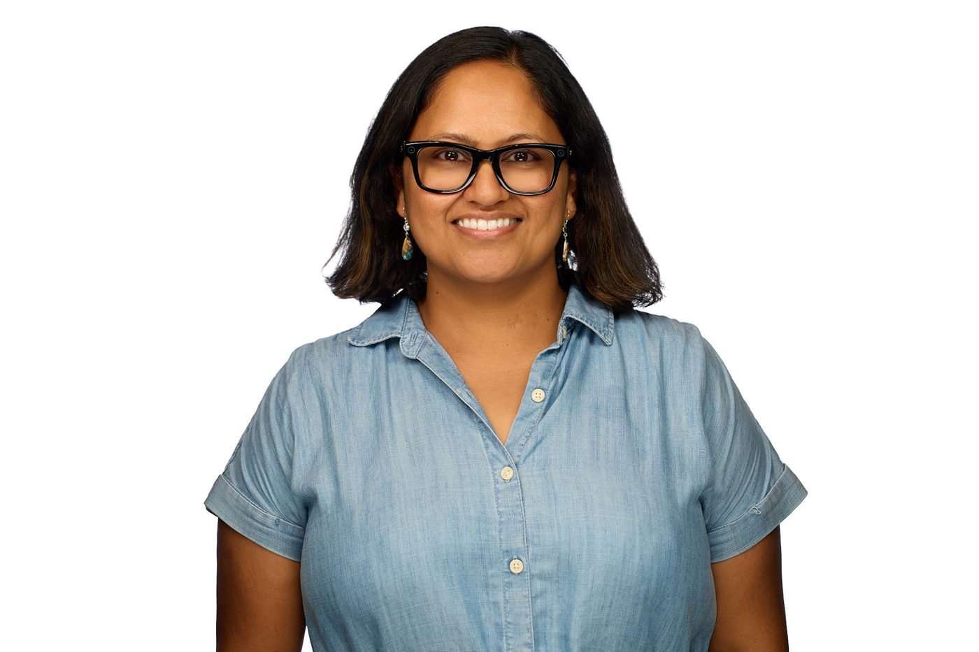 Smruti Phadnis, smiling, in a blue chambray shirt